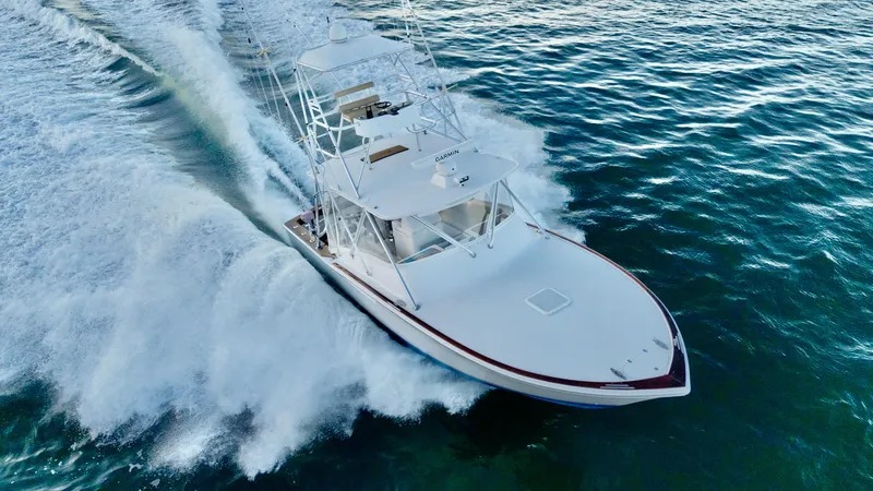 Slide: The Image of A 2004 Predator 35 boat cruising swiftly on open water. - 22