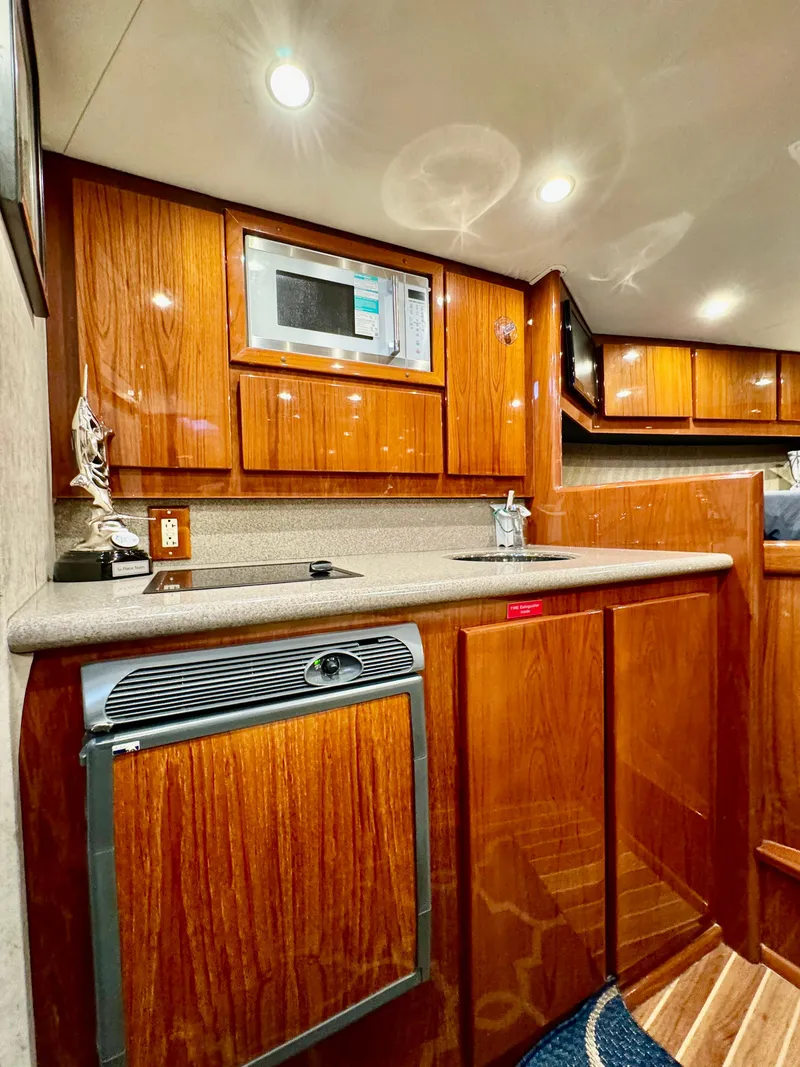 Slide: The Image of Luxurious 2004 Predator 35 yacht kitchen with wood cabinetry and modern appliances. - 23