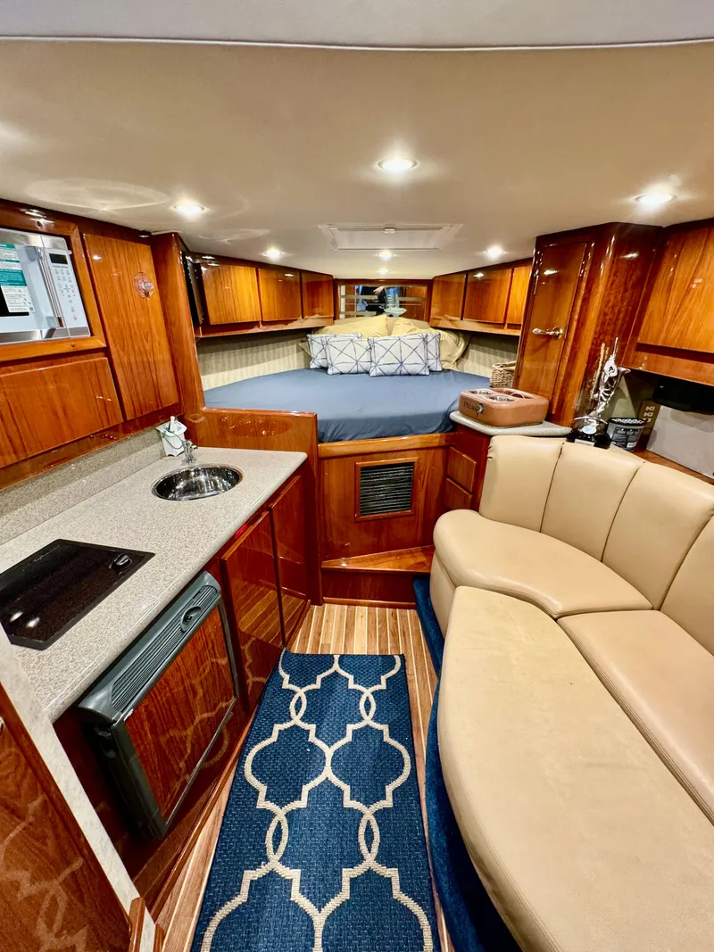 Slide: The Image of Luxurious interior of a 2004 Predator 35 yacht with wood finishes and cozy seating. - 25