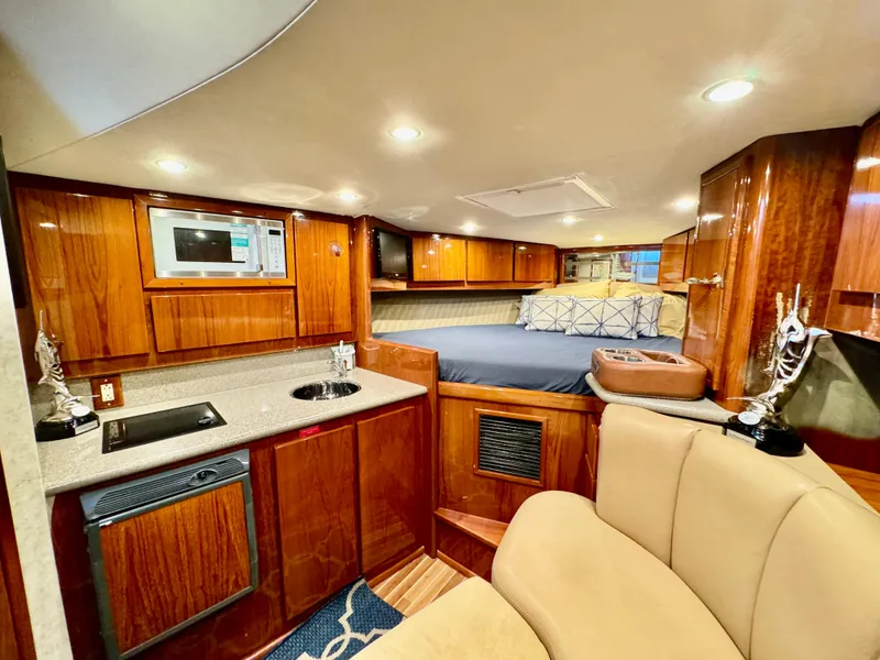 Slide: The Image of Luxurious interior of a 2004 Predator 35 yacht with wood cabinetry and cozy sleeping area. - 4