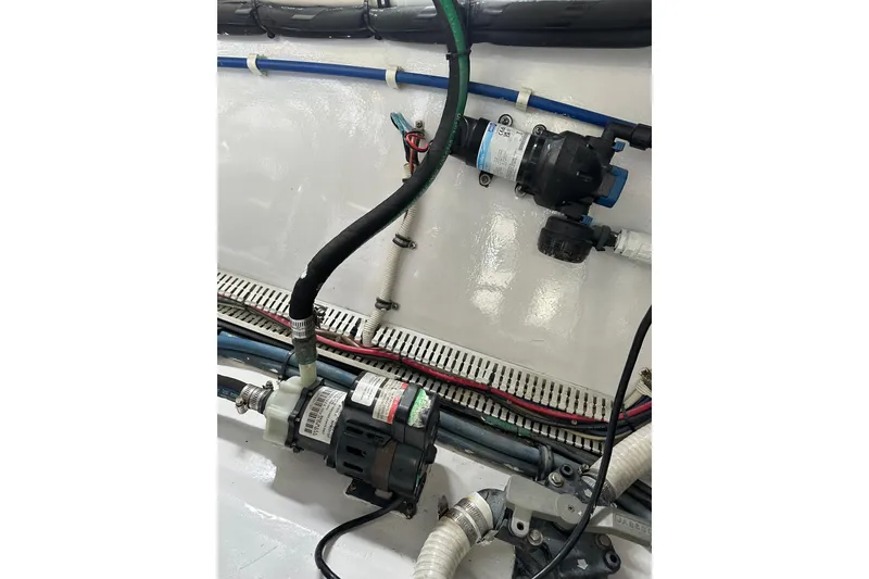 Slide: The Image of Engine compartment of a 2004 Predator 35 boat, showcasing pumps and wiring. - 44