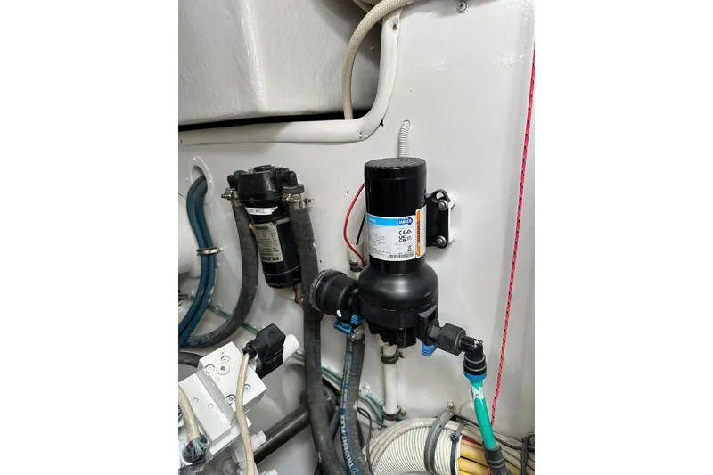 Slide: The Image of Engine compartment of a 2004 Predator 35 boat, featuring plumbing and filtration systems. - 46