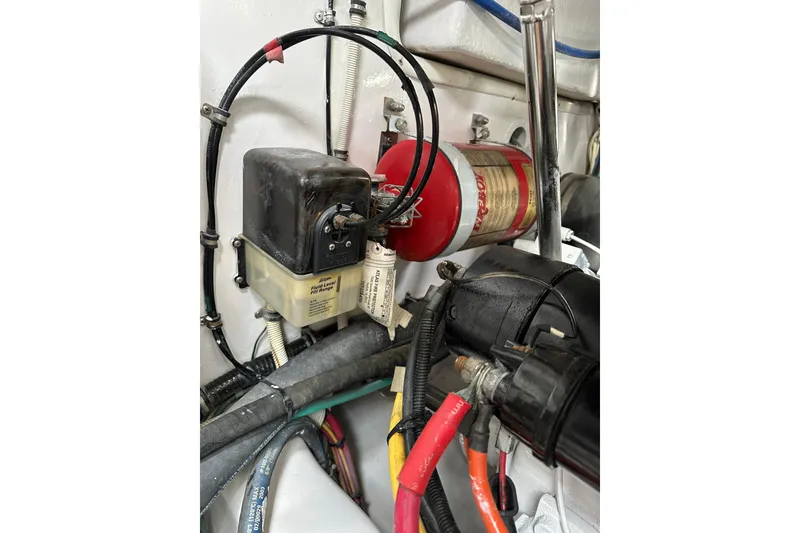 Slide: The Image of Engine compartment of a 2004 Predator 35 boat with fire extinguisher and wiring. - 47