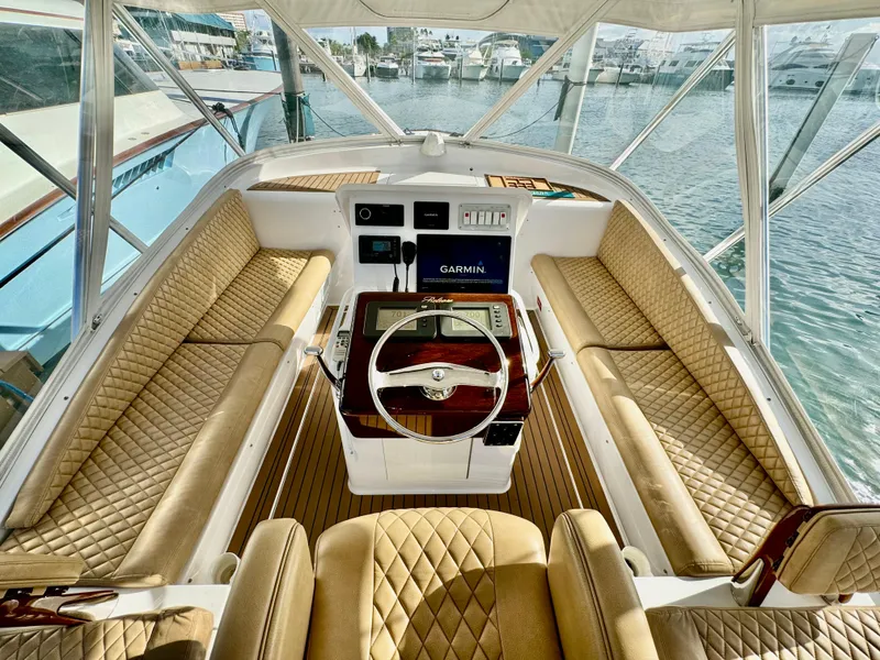 Slide: The Image of Luxurious 2004 Predator 35 yacht interior with tan quilted seating and modern navigation system. - 5
