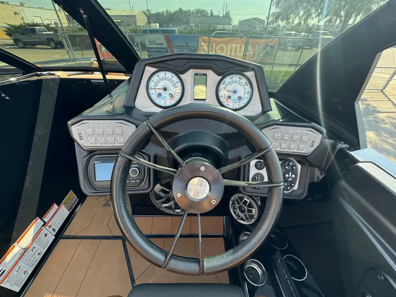Slide: The Image of 2021 Axis A22 boat dashboard with steering wheel and control panel. - 20