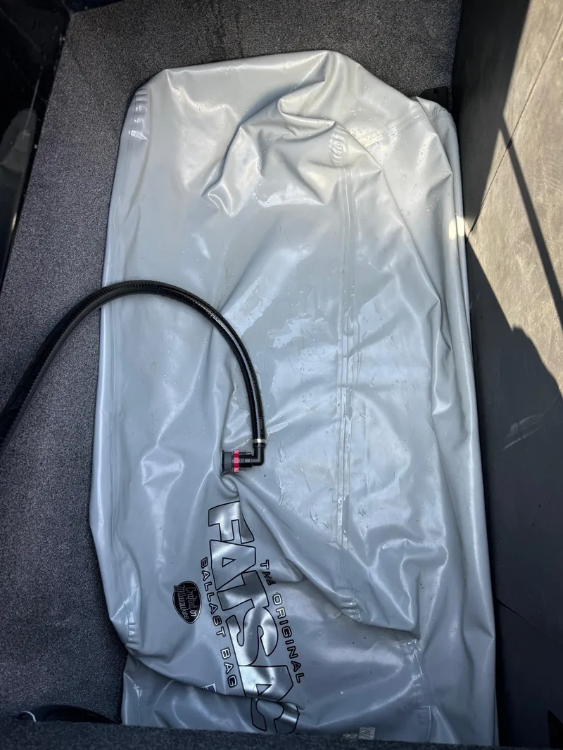 Slide: The Image of Ballast bag in 2021 Axis A22 boat compartment with hose attached. - 24