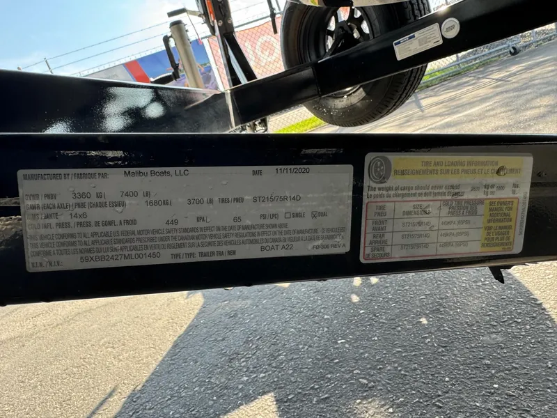 Slide: The Image of Label on Axis A22 trailer, detailing specifications and tire information. - 26