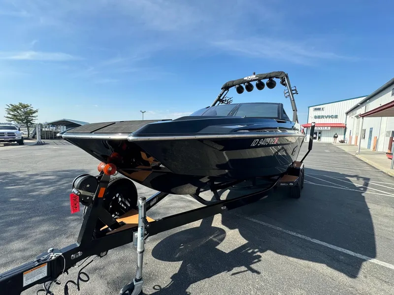 Slide: The Image of 2021 Axis A22 boat on trailer in parking lot, sunny day. - 5