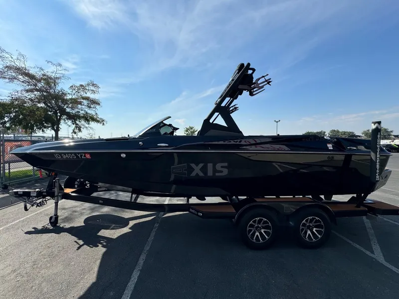 Slide: The Image of 2021 Axis A22 boat on trailer in parking lot, side view. - 6
