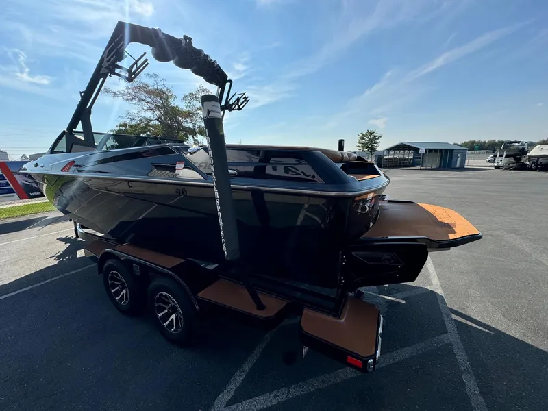 Slide: The Image of 2021 Axis A22 boat on trailer in parking lot, sunny day. - 7