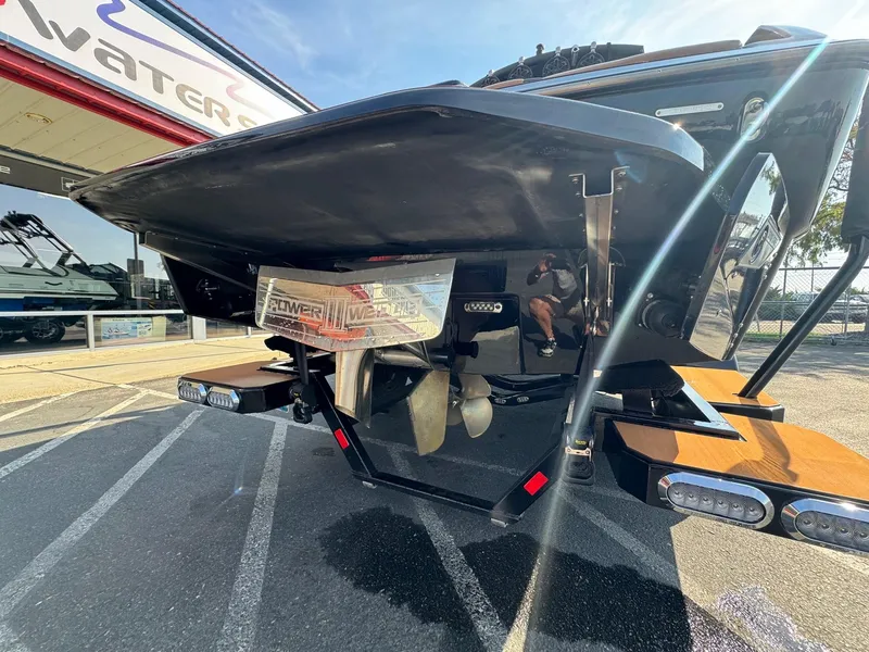 Slide: The Image of 2021 Axis A22 boat rear view with propeller and swim platform in a showroom. - 8