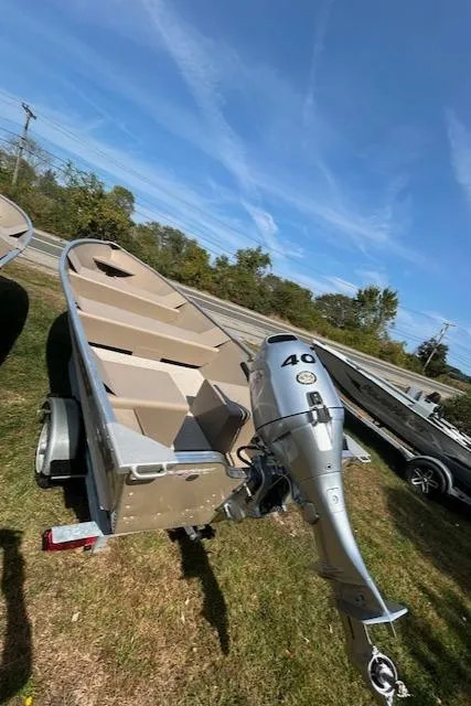 Slide: The Image of 2024 Polar Kraft Dakota 1670T boat with outboard motor on trailer, outdoors. - 3