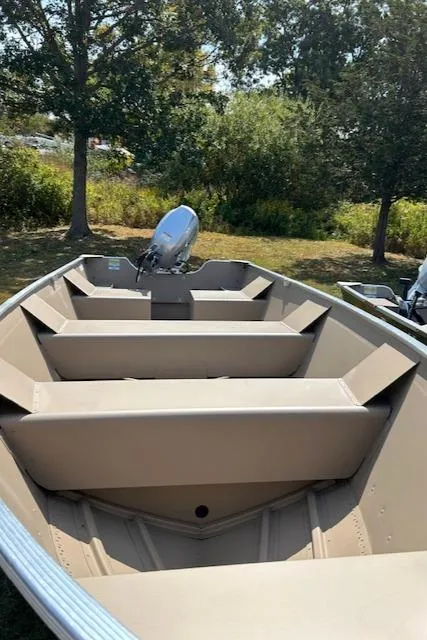 Slide: The Image of 2024 Polar Kraft Dakota 1670T boat, beige interior, outdoors, under trees. - 4