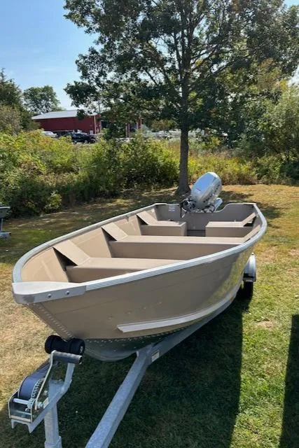 Slide: The Image of 2024 Polar Kraft Dakota 1670T boat on trailer, outdoors in a grassy area. - 5