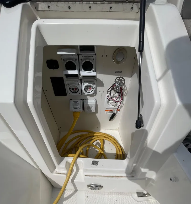 Slide: The Image of 2020 Sea Ray Sundancer 320 electrical panel with yellow cables and outlets. - 10