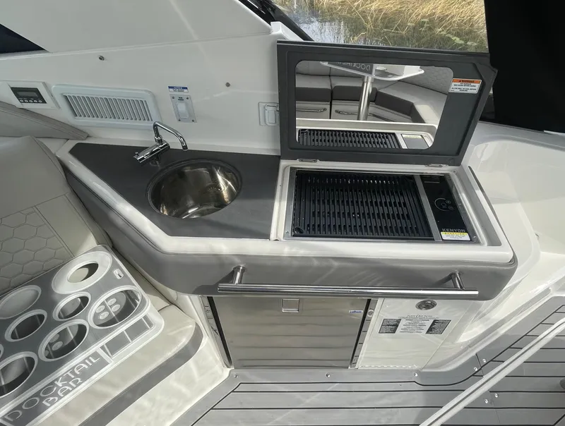 Slide: The Image of 2020 Sea Ray Sundancer 320 boat kitchenette with sink and grill. - 17