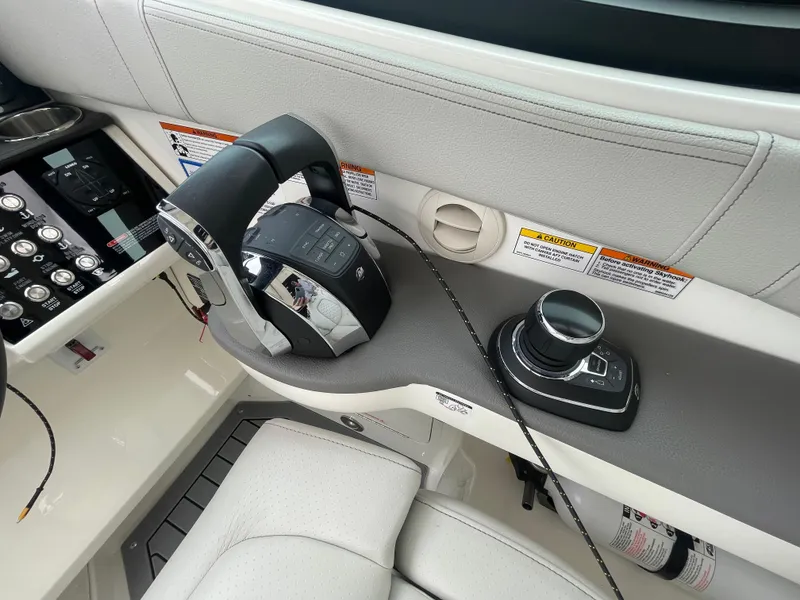 Slide: The Image of 2020 Sea Ray Sundancer 320 helm controls with joystick and throttle. - 20