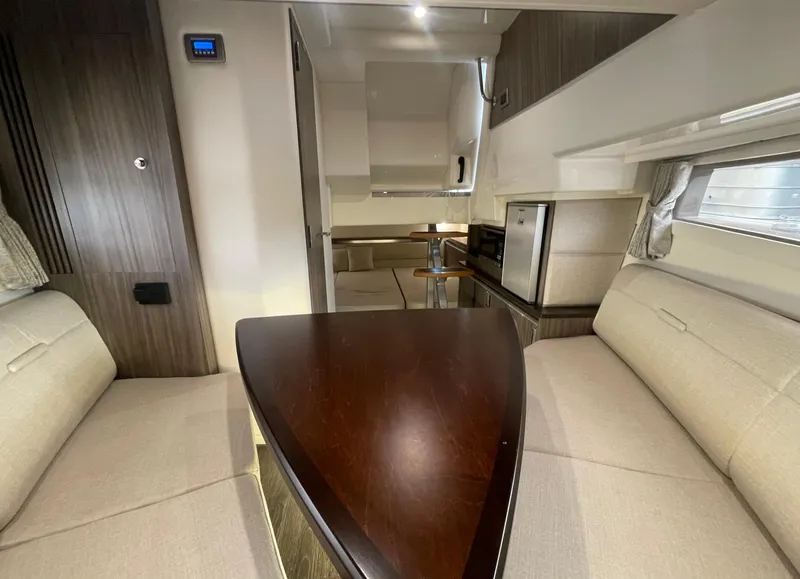 Slide: The Image of Interior of 2020 Sea Ray Sundancer 320 yacht with modern seating and kitchenette. - 21