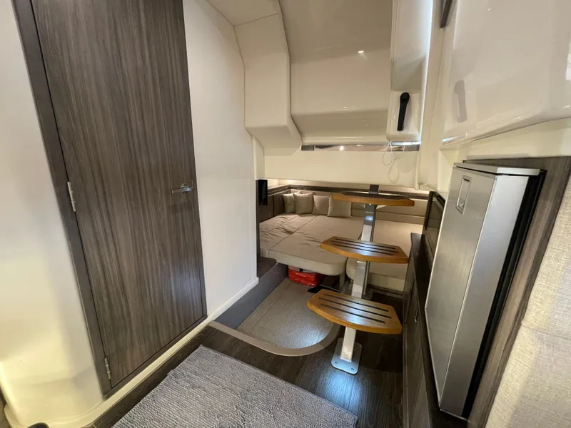 Slide: The Image of Interior of 2020 Sea Ray Sundancer 320, featuring modern design and compact dining area. - 22