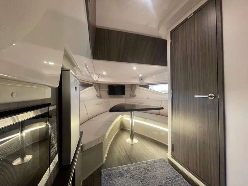 Slide: The Image of Luxurious interior of 2020 Sea Ray Sundancer 320 yacht with modern seating and table. - 25