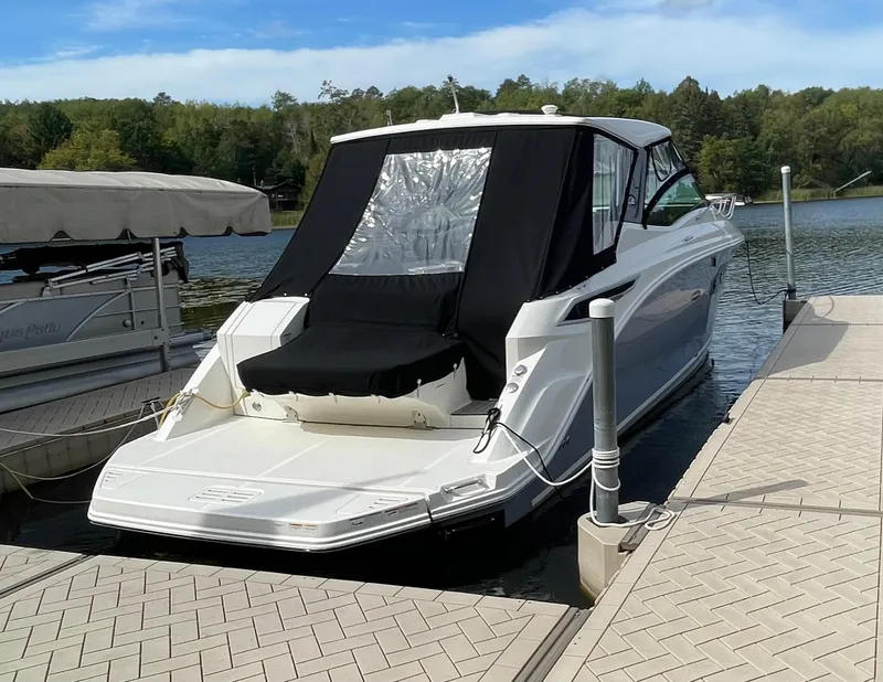 Slide: The Image of 2020 Sea Ray Sundancer 320 docked at a serene lakeside marina. - 4