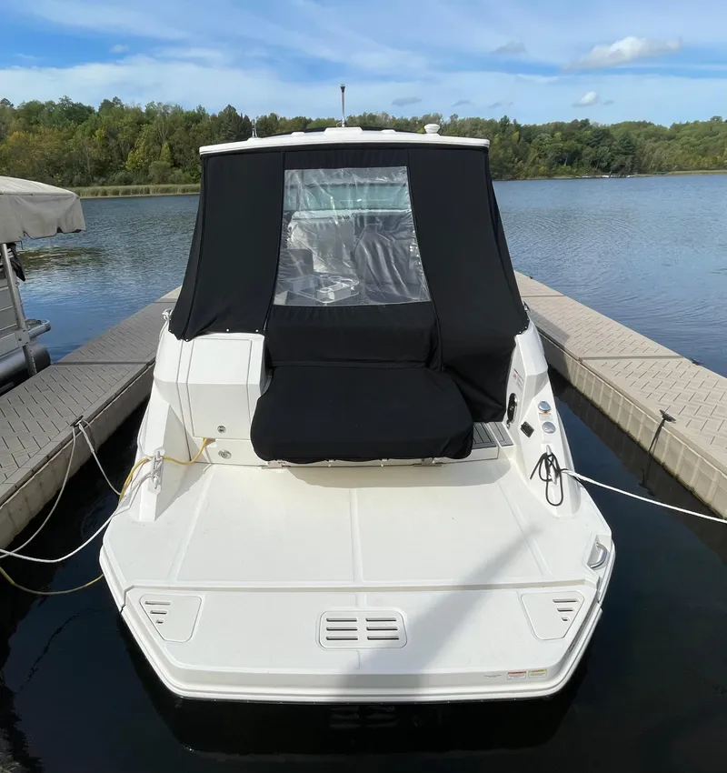 Slide: The Image of 2020 Sea Ray Sundancer 320 docked on a calm lake with lush greenery. - 5