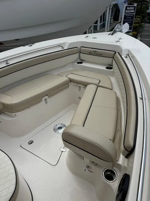 Slide: The Image of 2022 Sea Chaser 22 HFC boat interior with beige seating and sleek design. - 14