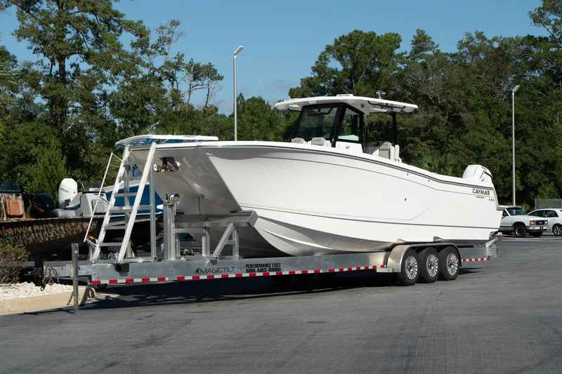 Slide: The Image of 2025 Caymas 34 CT boat on a trailer, parked outdoors. - 1
