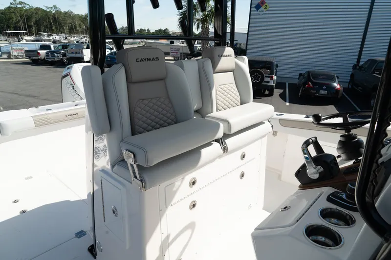 Slide: The Image of 2025 Caymas 34 CT boat interior with cushioned seating and control panel. - 19