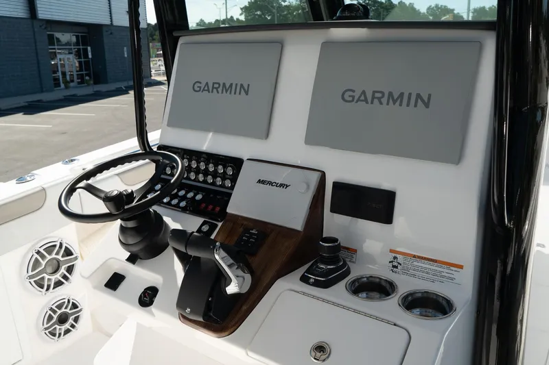 Slide: The Image of 2025 Caymas 34 CT boat dashboard with Garmin displays and Mercury controls. - 20