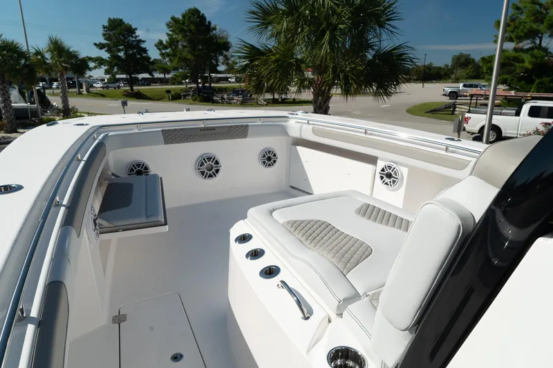 Slide: The Image of 2025 Caymas 34 CT boat interior with cushioned seating and speakers, set against a sunny backdrop. - 22