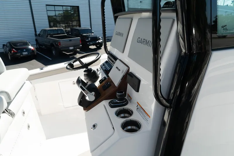 Slide: The Image of 2025 Caymas 34 CT boat cockpit with Garmin navigation system and steering wheel. - 23