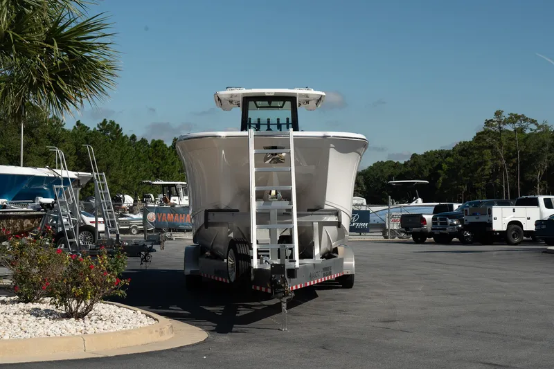 Slide: The Image of 2025 Caymas 34 CT boat on trailer in parking lot, surrounded by trees and vehicles. - 5