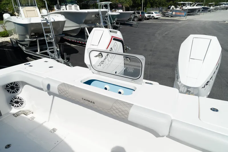 Slide: The Image of 2025 Caymas 34 CT boat with open storage compartment and twin engines. - 6