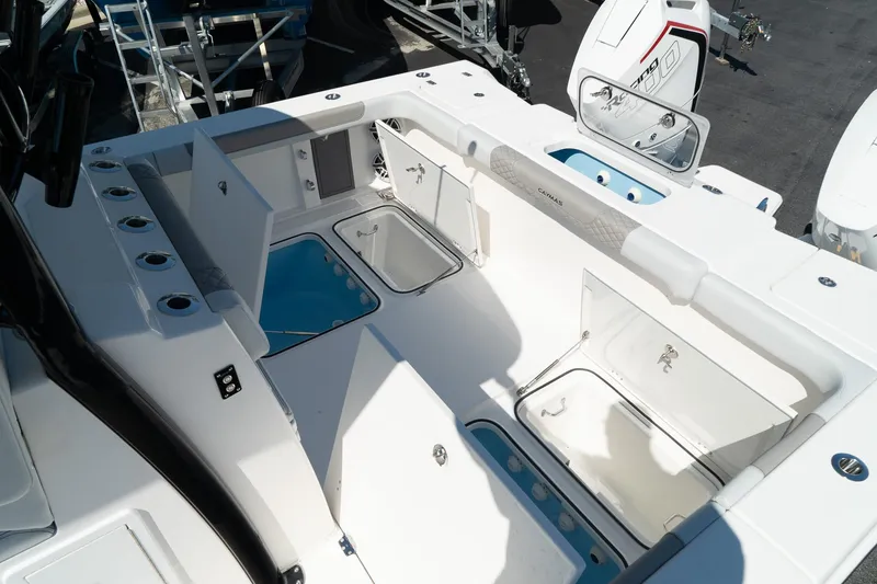 Slide: The Image of 2025 Caymas 34 CT boat interior with storage compartments and seating area. - 8