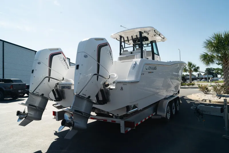 Slide: The Image of 2025 Caymas 34 CT boat with dual outboard engines on a trailer. - 9