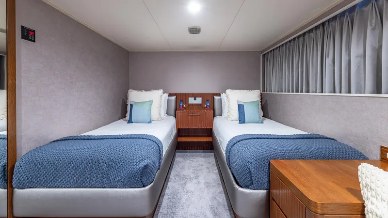 Slide: The Image of Twin bedroom on 1985 Feadship Custom yacht with modern decor and blue accents. - 12