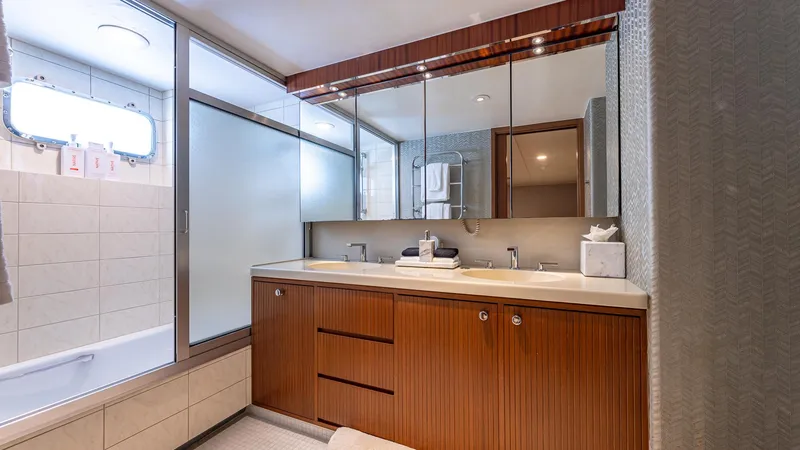 Slide: The Image of Luxurious bathroom on 1985 Feadship Custom yacht, featuring wood cabinetry and modern fixtures. - 14