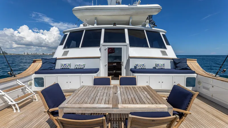 Slide: The Image of Luxury Feadship Custom yacht deck with seating, table, and ocean view, 1985 model. - 20