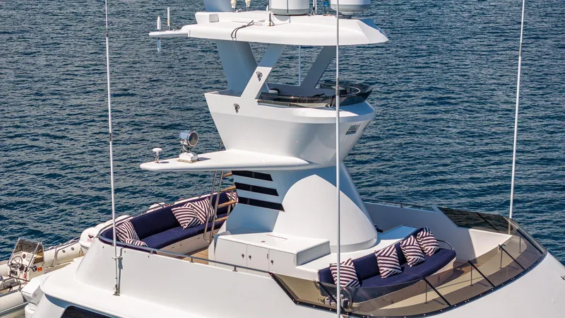 Slide: The Image of Luxurious 1985 Feadship Custom yacht with elegant deck seating and ocean backdrop. - 22