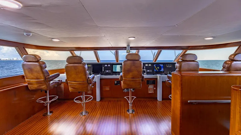 Slide: The Image of Luxurious Feadship Custom yacht bridge interior with leather seats, wood flooring, and ocean view, 1985 model. - 27