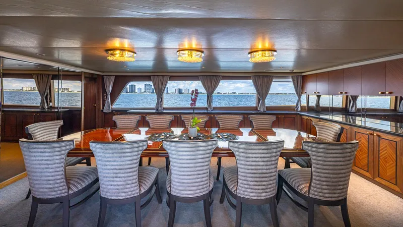 Slide: The Image of Luxurious dining area on 1985 Feadship Custom yacht with elegant chairs and panoramic windows. - 3