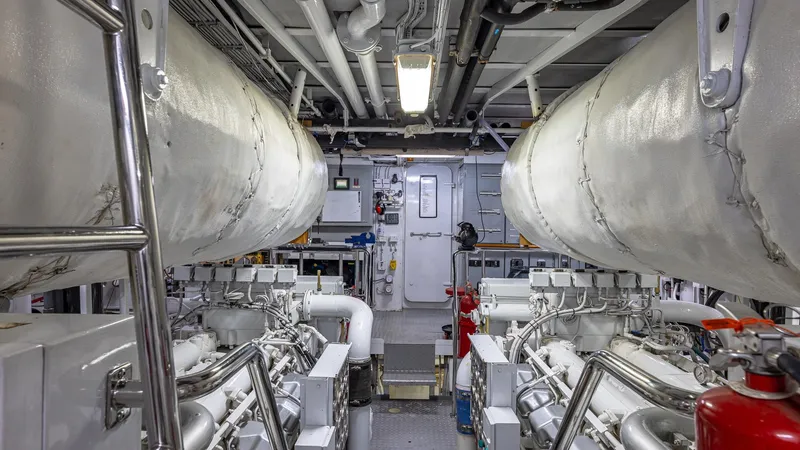 Slide: The Image of Engine room of 1985 Feadship Custom yacht, showcasing machinery and pipes. - 30