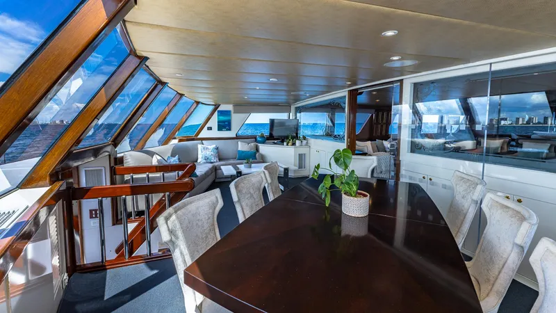 Slide: The Image of Luxurious interior of 1985 Feadship Custom yacht with elegant dining area and panoramic ocean views. - 6