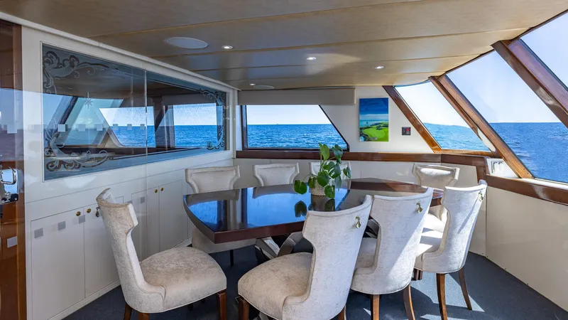 Slide: The Image of Luxurious dining area on 1985 Feadship Custom yacht with ocean view. - 7