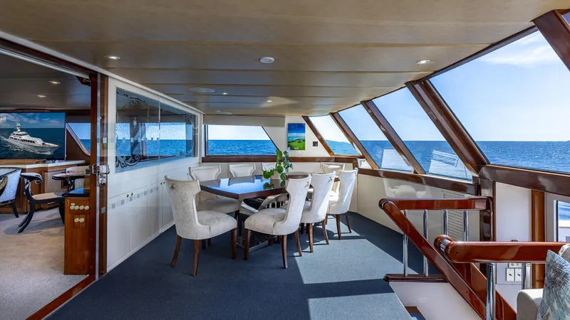 Slide: The Image of Luxurious 1985 Feadship Custom yacht interior with ocean view and elegant dining area. - 8