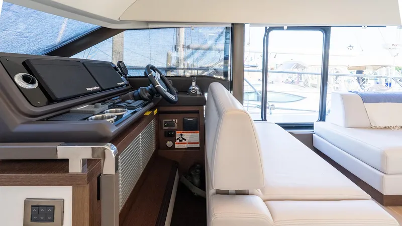 Slide: The Image of Interior of 2019 Prestige 520 Flybridge yacht with modern helm and white seating. - 13