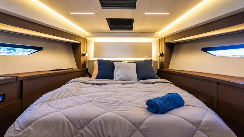 Slide: The Image of Luxurious bedroom interior of 2019 Prestige 520 Flybridge yacht with modern lighting and cozy bedding. - 17