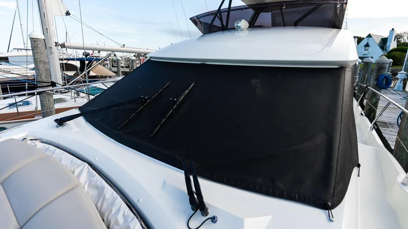 Slide: The Image of 2019 Prestige 520 Flybridge yacht with covered windshield at marina. - 29