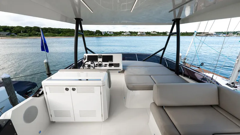 Slide: The Image of Flybridge of 2019 Prestige 520 yacht with seating, helm, and ocean view. - 32